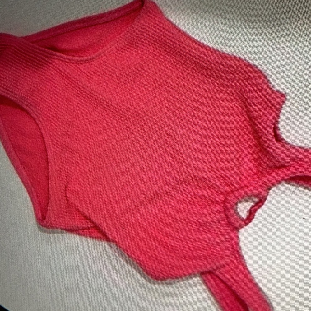 Features heart shaped cutout kid’s one piece